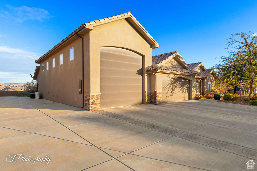View of property exterior with a garage
