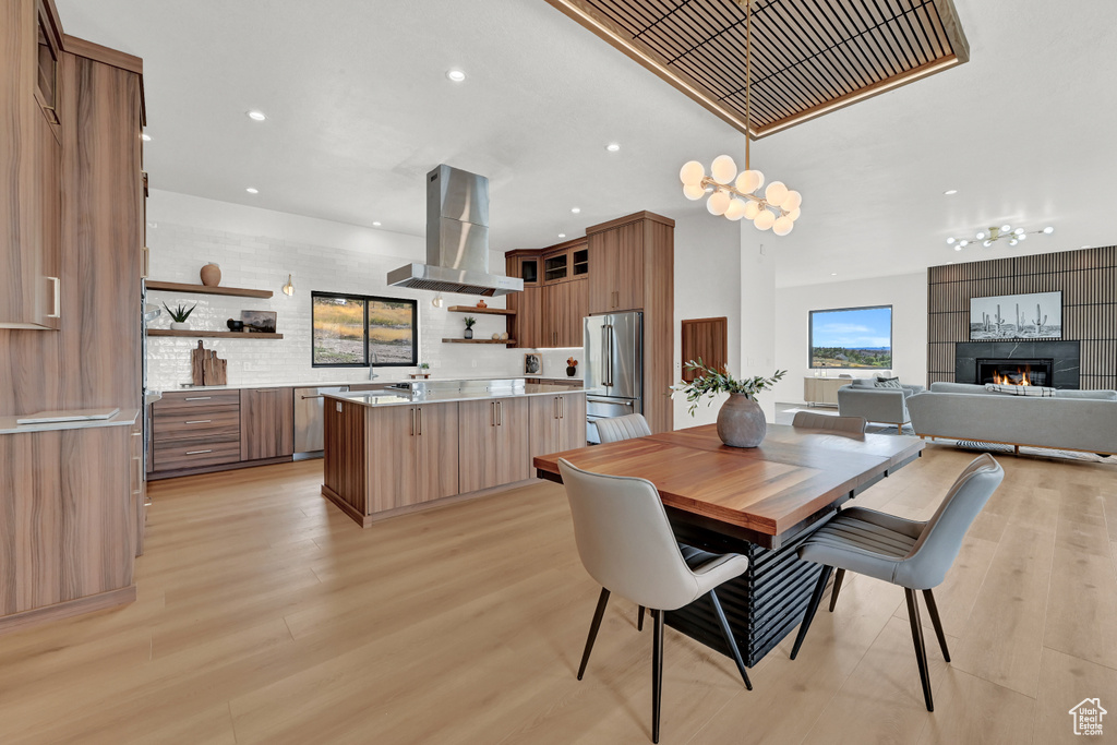 Dining space featuring a fireplace and light wood-type flooring