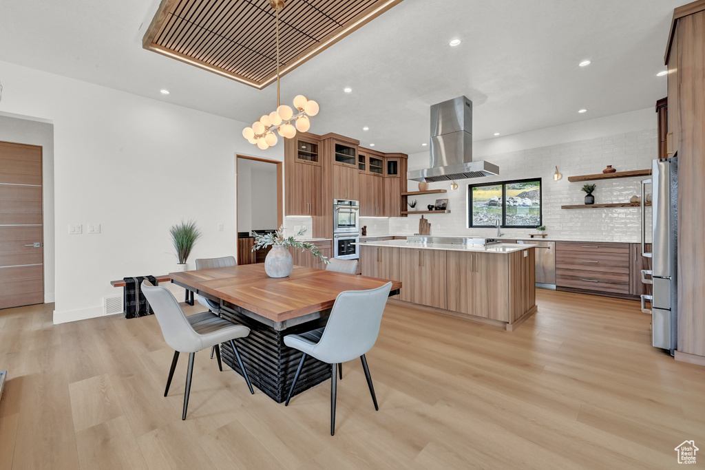 Dining space with light hardwood / wood-style floors