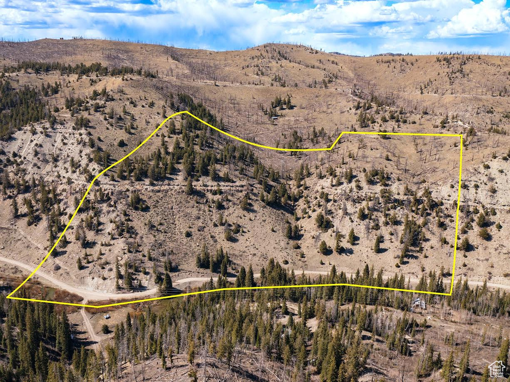 View of rural area featuring property parcel outlined, a mountain backdrop, and a desert landscape