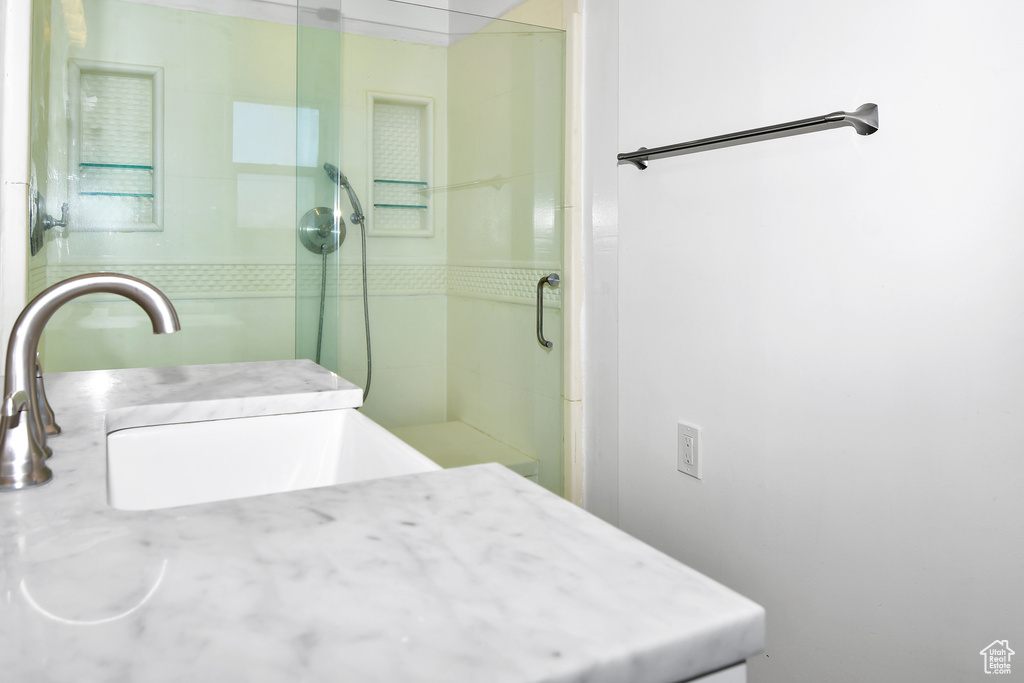 Bathroom with sink and an enclosed shower