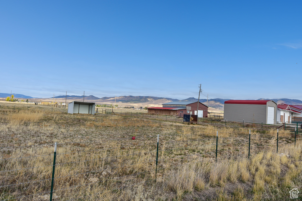 View of yard with a rural view and a mountain view