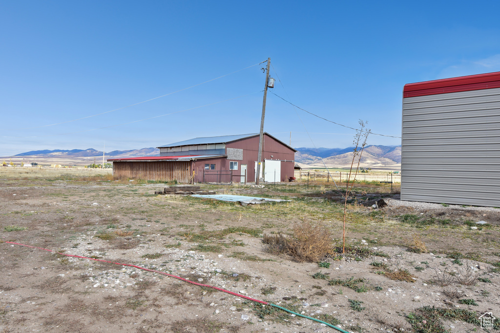 View of yard with a rural view and a mountain view