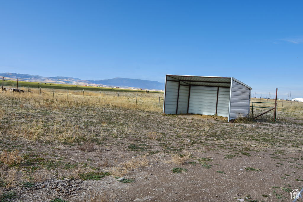 View of outbuilding with a rural view and a mountain view