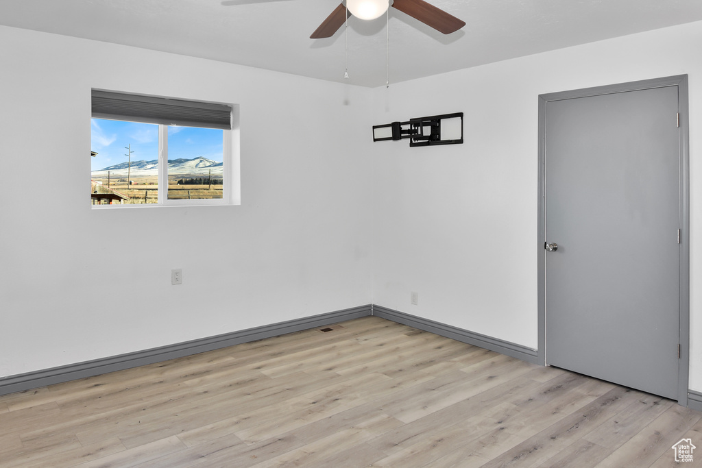 Spare room featuring ceiling fan and light hardwood / wood-style flooring