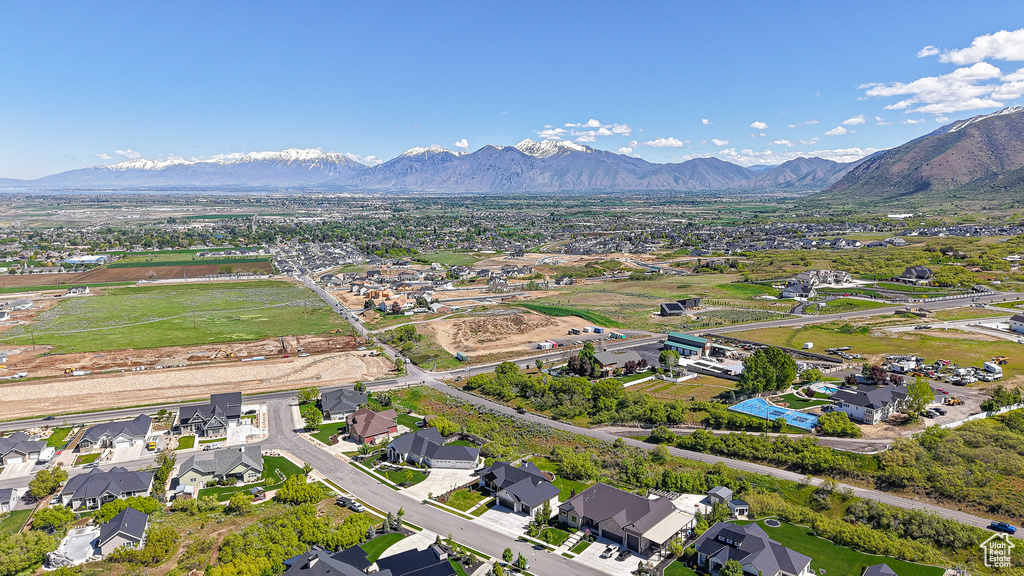 Aerial overview of property's location featuring a mountainous background and nearby suburban area