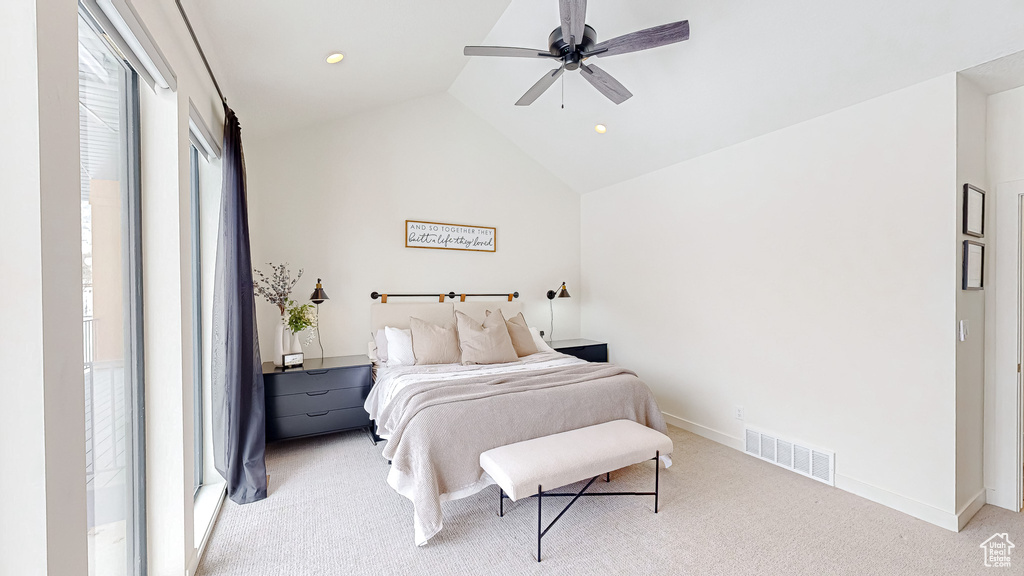 Bedroom featuring lofted ceiling, ceiling fan, and light colored carpet