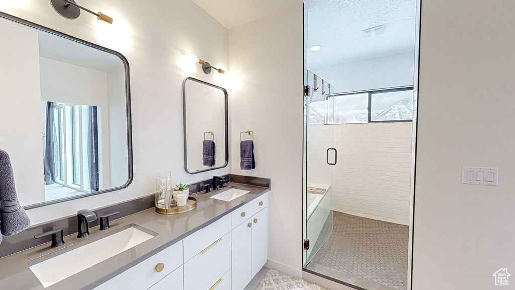 Bathroom featuring walk in shower and vanity