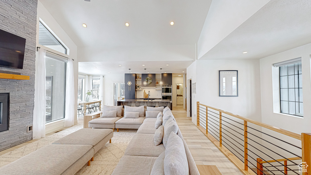 Living room with sink, a fireplace, and light hardwood / wood-style floors