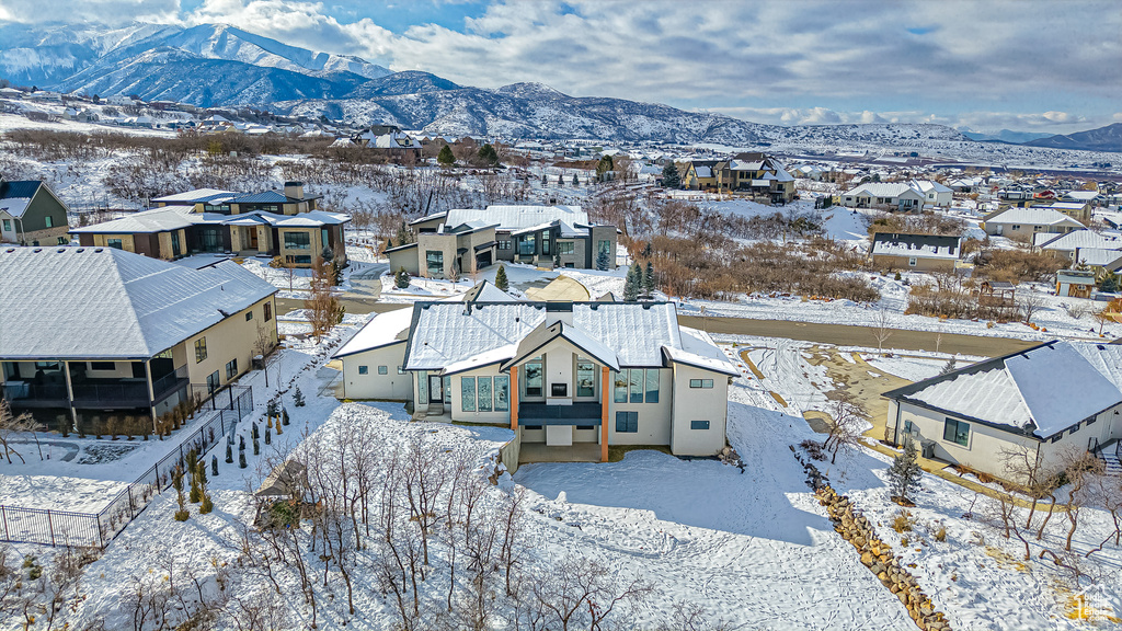 Snowy aerial view featuring a mountain view