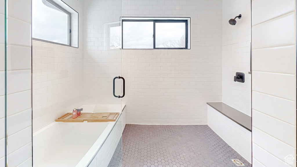 Bathroom with tile patterned flooring and plus walk in shower