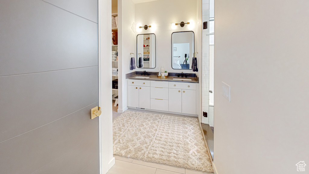 Bathroom featuring tile patterned floors and vanity