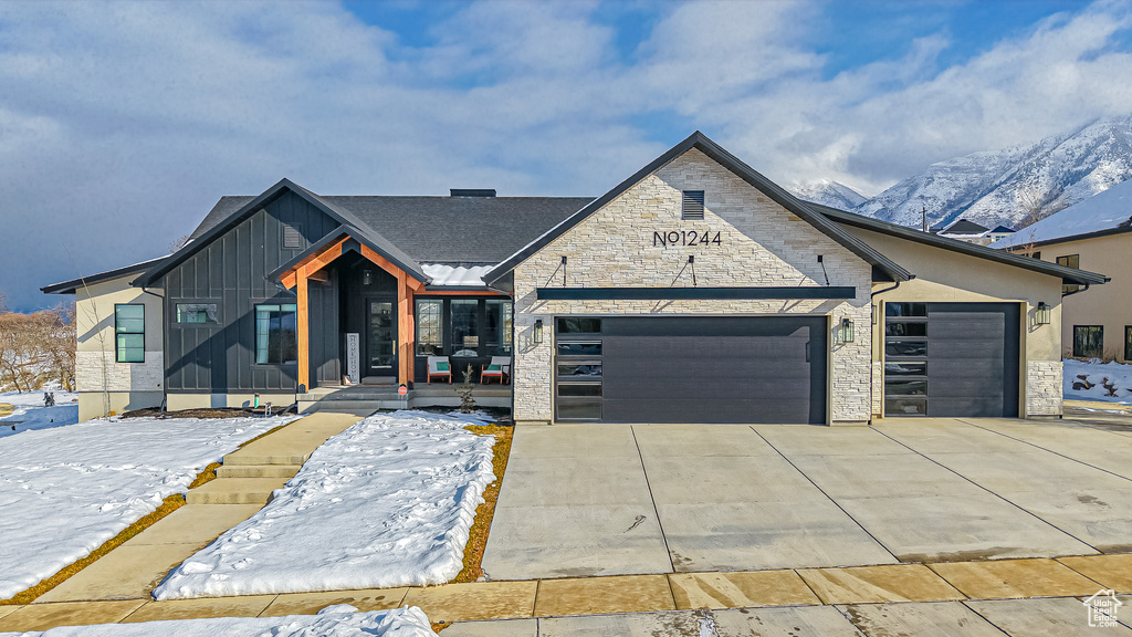 View of front of house featuring a garage and a mountain view