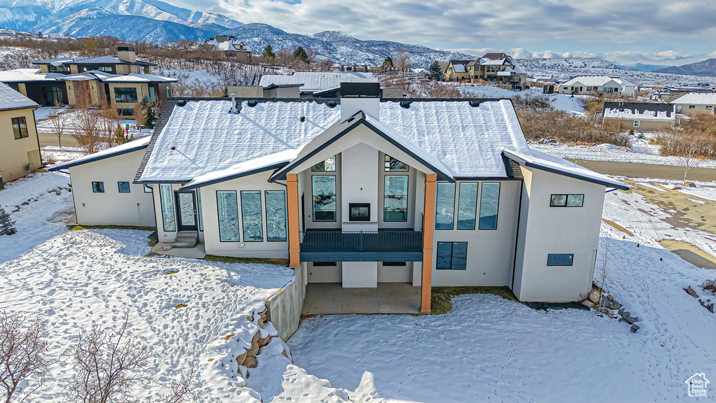 Snow covered house featuring a mountain view