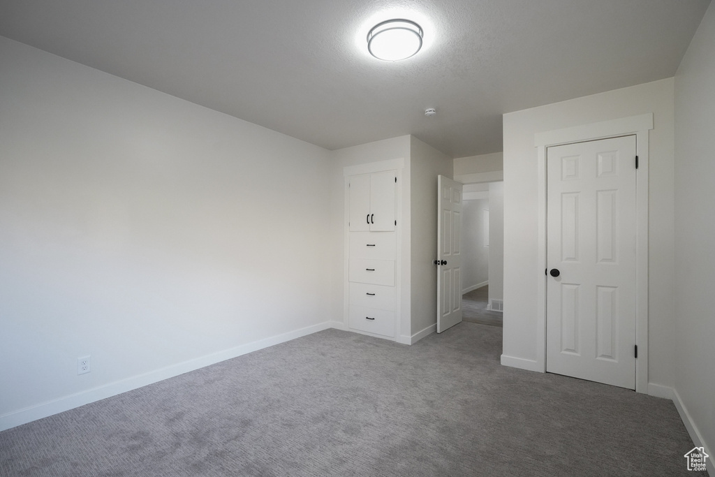 Unfurnished bedroom with carpet flooring