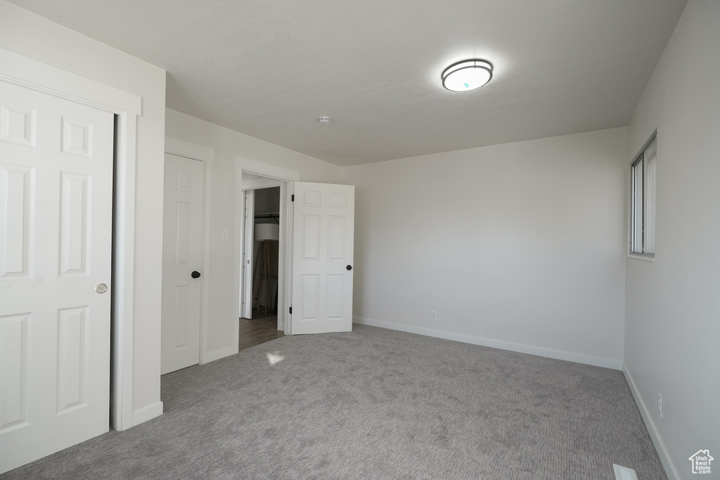 Unfurnished bedroom with carpet flooring