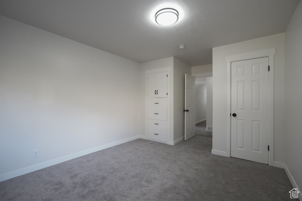 Unfurnished bedroom with carpet flooring and a textured ceiling