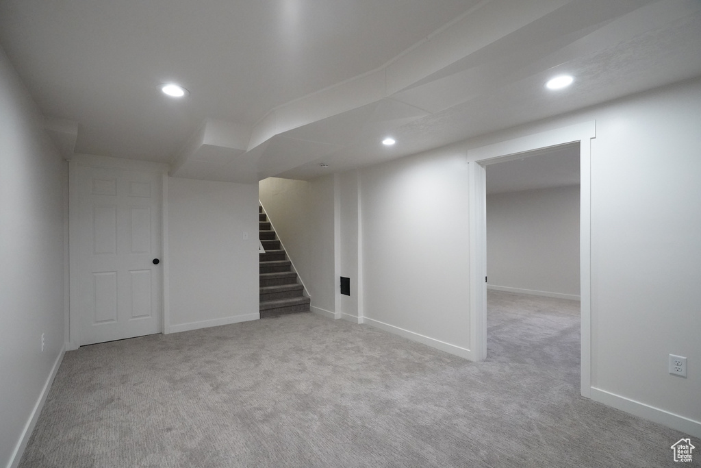 Basement with light colored carpet