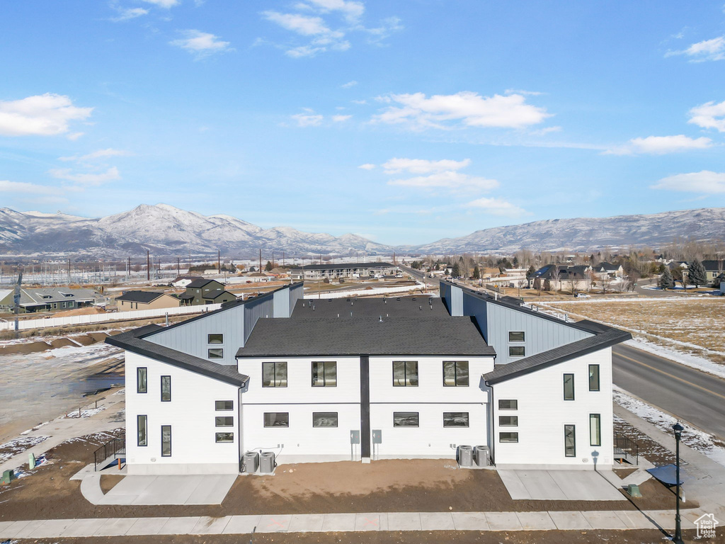 Rear view of property featuring central AC unit and a mountain view