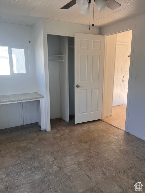Unfurnished bedroom with a closet and ceiling fan