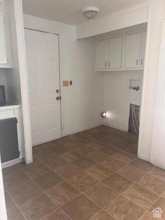 Washroom with cabinets and hookup for a washing machine