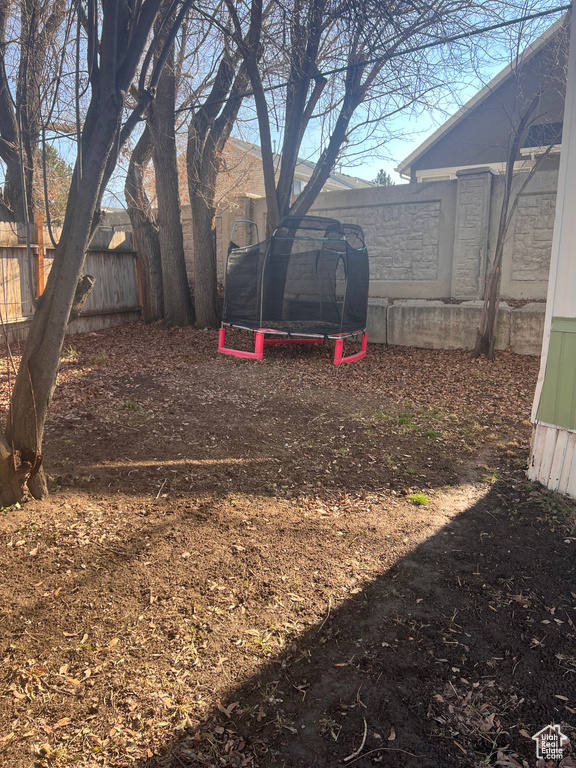 View of yard with a trampoline