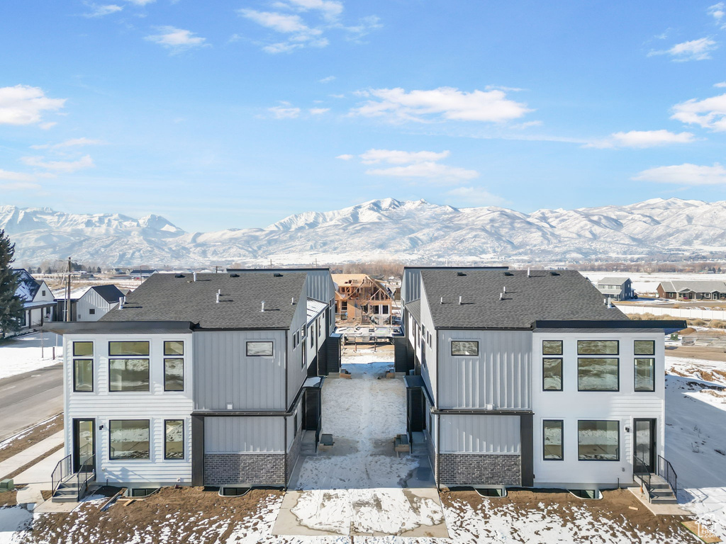 Snow covered property featuring a mountain view