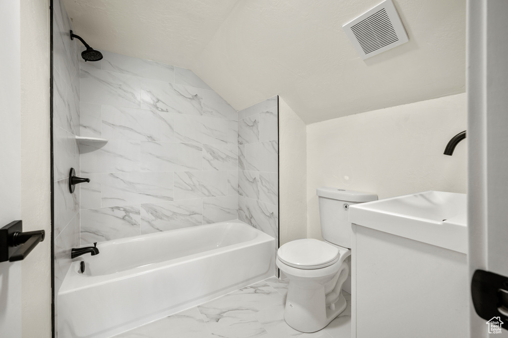 Full bathroom with shower / tub combination, lofted ceiling, marble finish flooring, and vanity