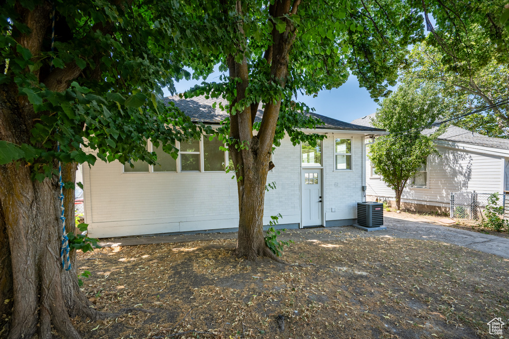 View of front of property with brick siding and a shingled roof