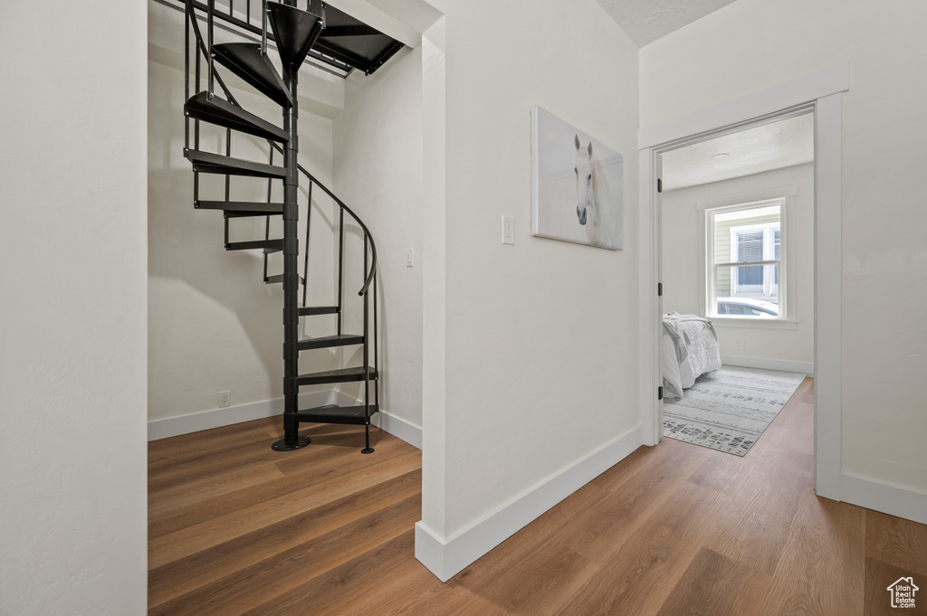 Staircase featuring wood finished floors and baseboards