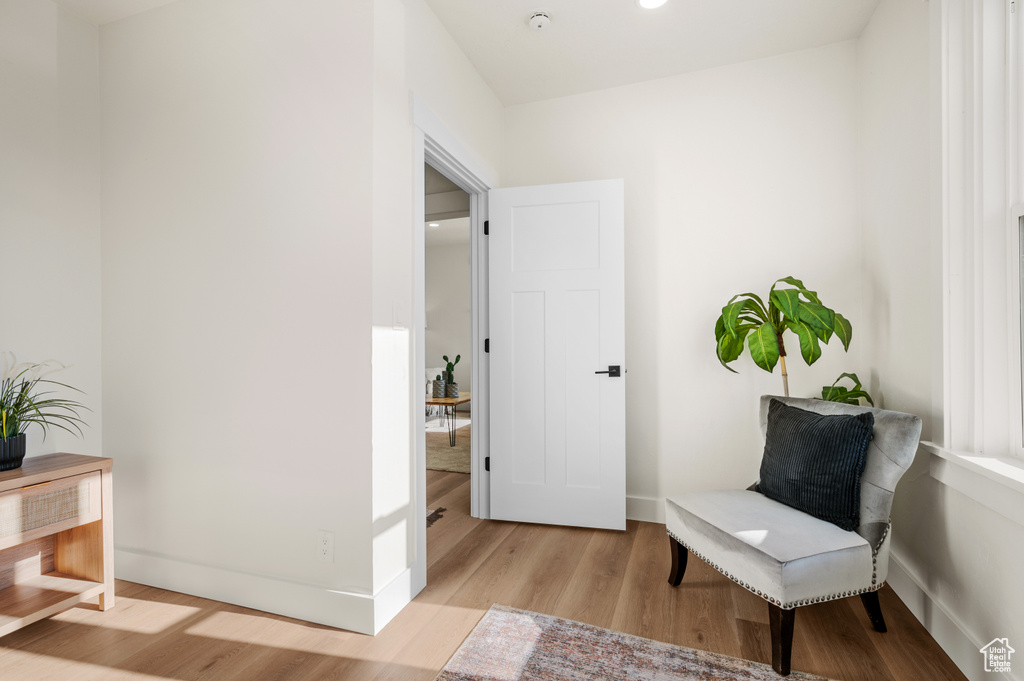 Sitting room featuring light wood-style floors and baseboards