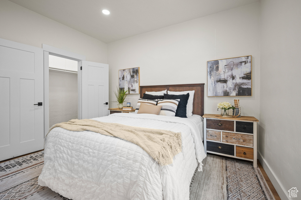 Bedroom with wood finished floors and recessed lighting
