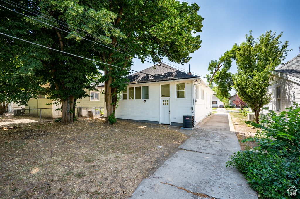 View of front of home featuring a shingled roof and concrete driveway