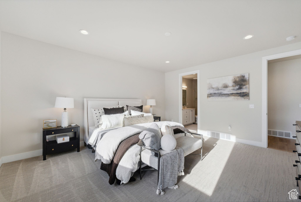 Bedroom with ensuite bathroom and carpet floors