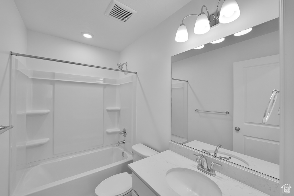 Bathroom featuring toilet, vanity, and shower / bathtub combination
