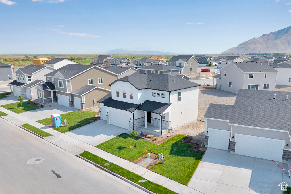 Aerial perspective of suburban area with a mountainous background