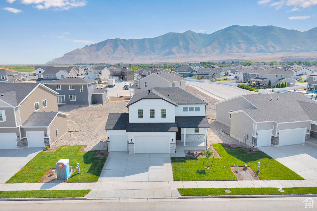 Aerial perspective of suburban area featuring a mountainous background