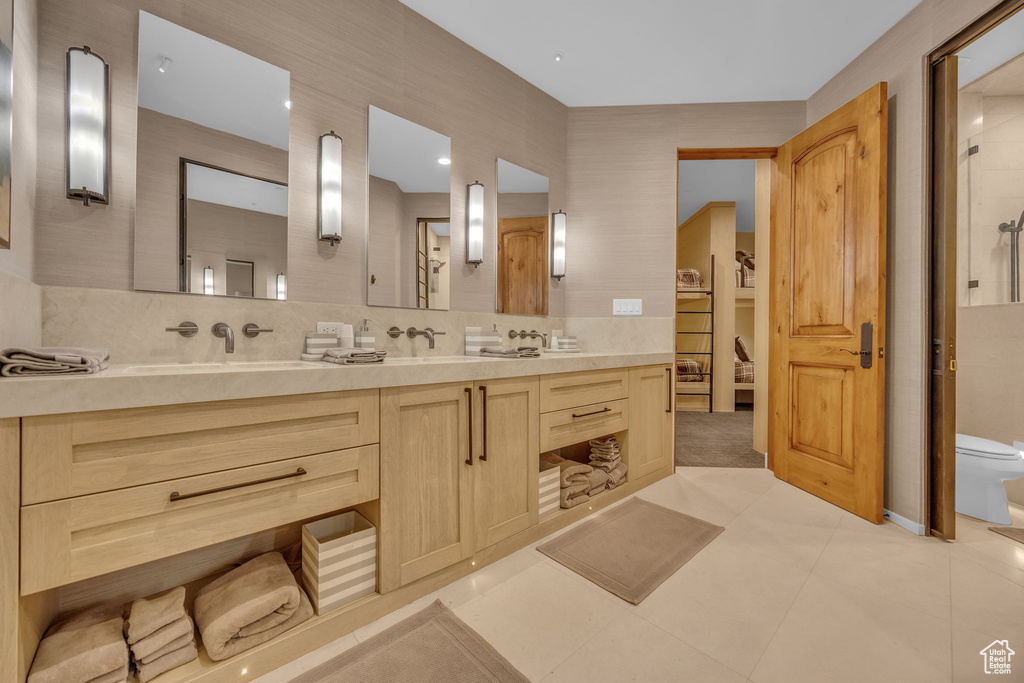 Full bath with double vanity and tile patterned floors