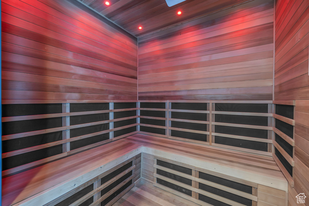 Relaxing sauna / steam room featuring wooden ceiling and wooden walls
