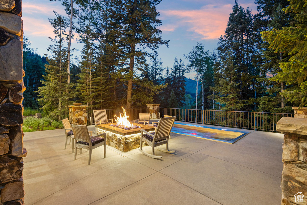 View of patio featuring an outdoor fire pit