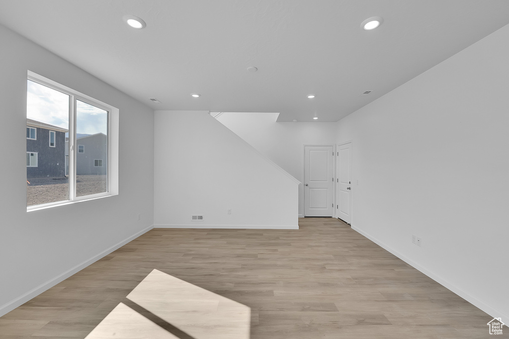 Unfurnished room with light wood-style floors, recessed lighting, and baseboards