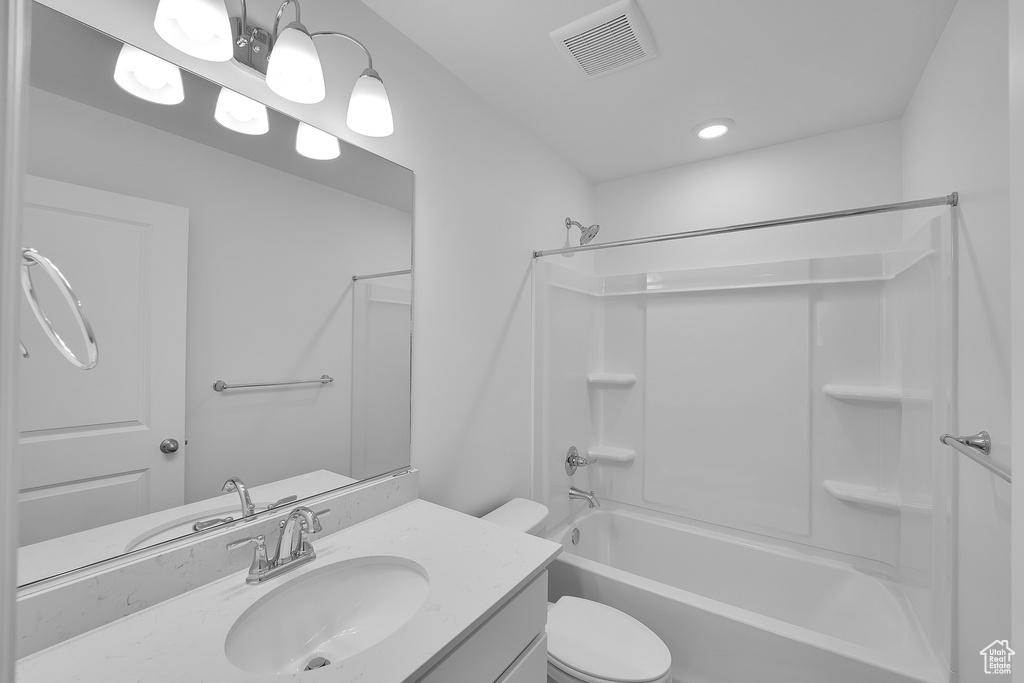 Bathroom featuring vanity, shower / bath combination, toilet, and recessed lighting