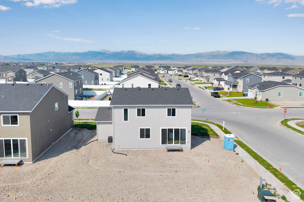 Aerial view of residential area featuring a mountain backdrop