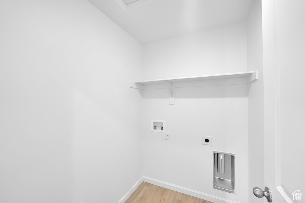 Laundry area with washer hookup, light wood-style flooring, baseboards, and electric dryer hookup