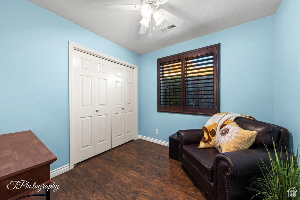 Sitting room featuring ceiling fan and dark hardwood / wood-style flooring