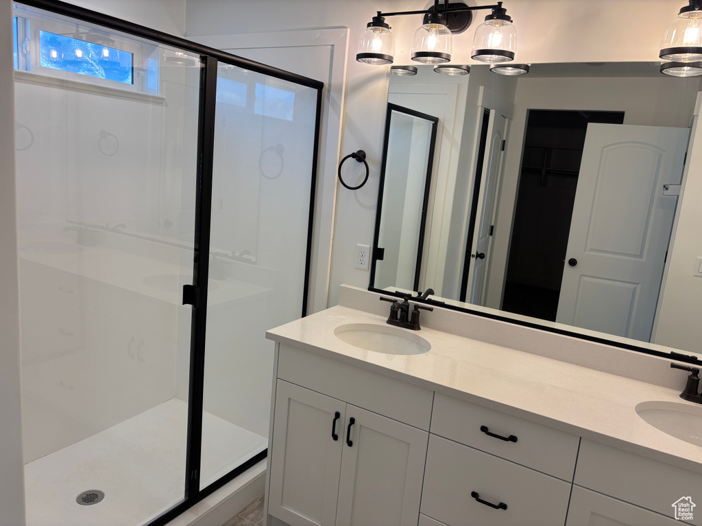 Bathroom with vanity and a shower with shower door
