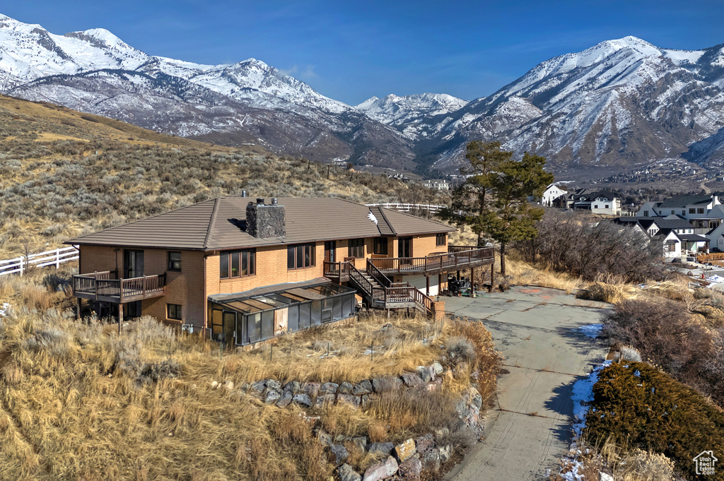 Back of property with a deck with mountain view