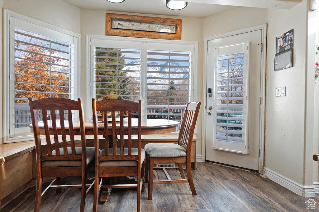 Dining space with hardwood / wood-style flooring