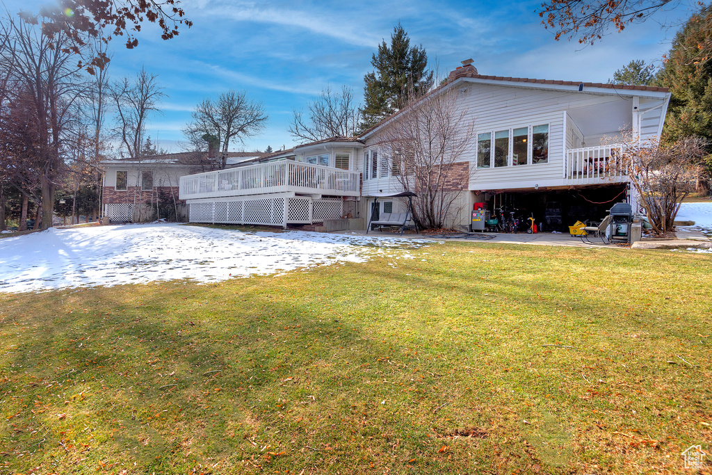 Rear view of house featuring a yard