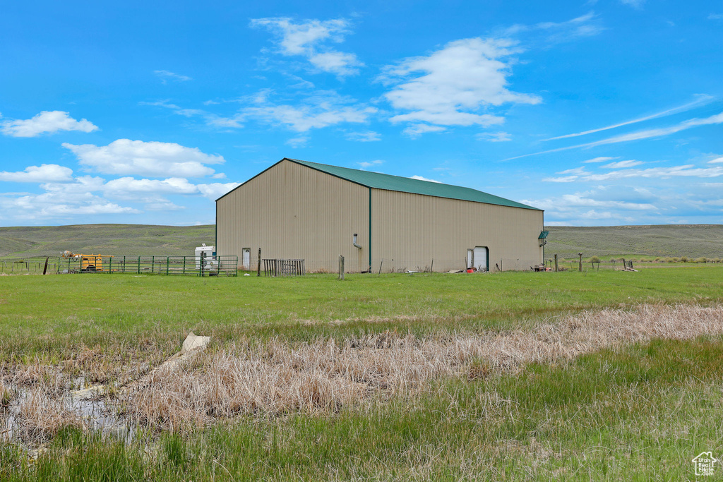 View of pole building with a rural view